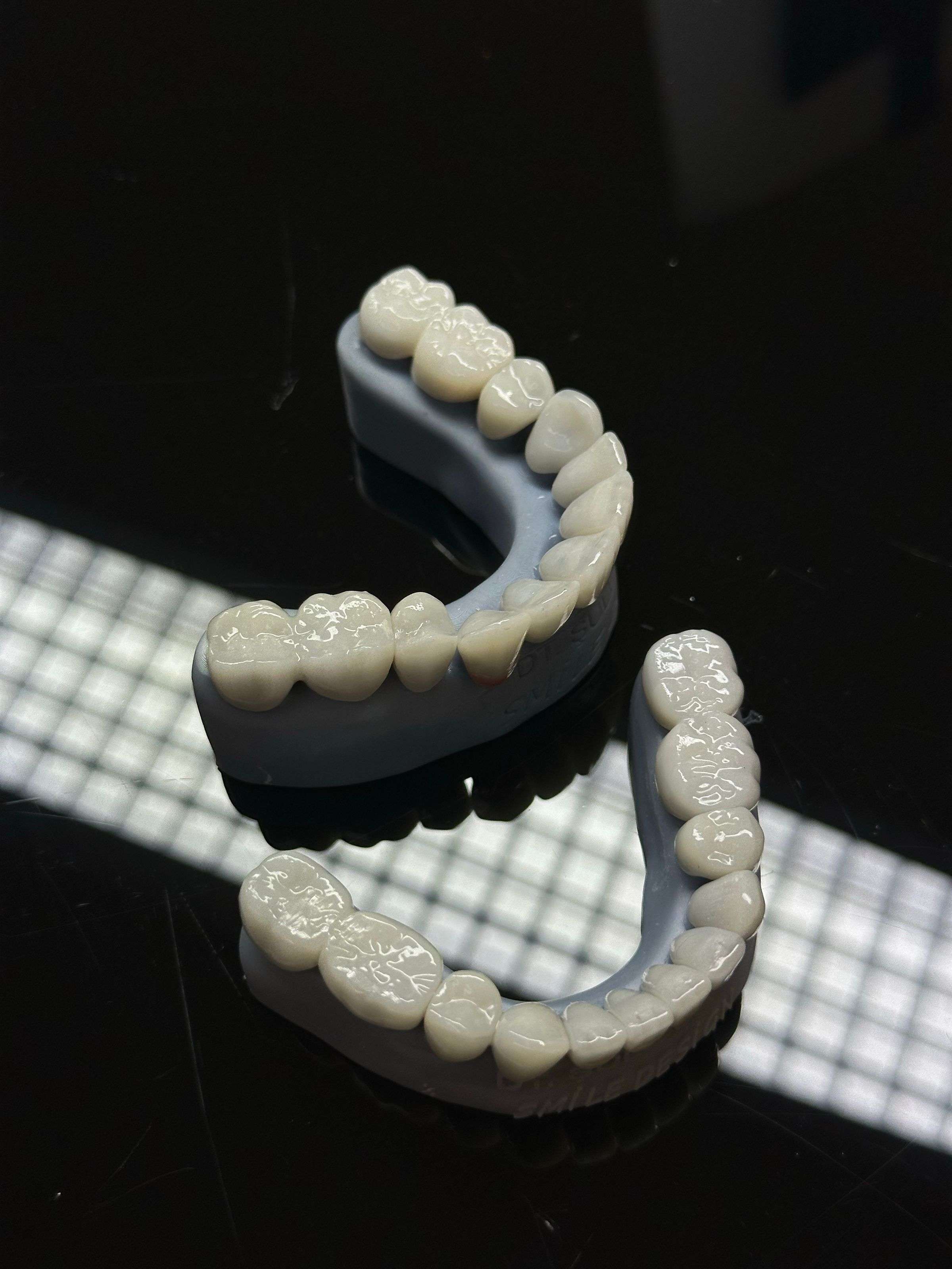 Ceramic crowns on a dark reflective surface